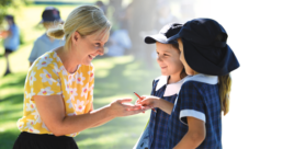 Teacher outside with two students
