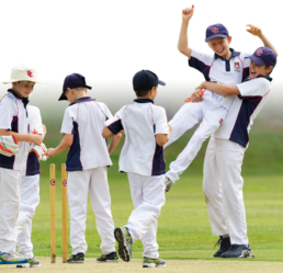 Junior sport students playing cricket